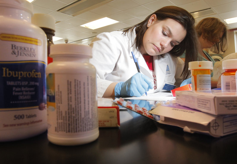 Sarah DeRaps, a sophomore at the University of New England College of Pharmacy, logs medications that were handed in at the school on Saturday. The college is studying, among other factors, which medications are over-prescribed.