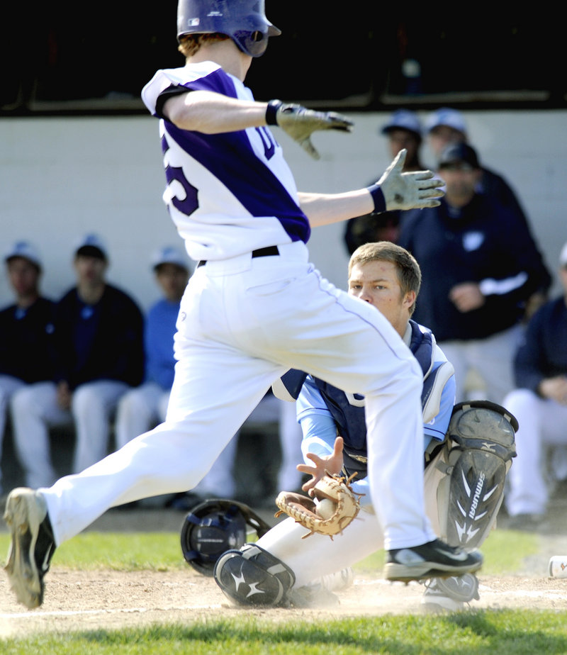 Westbrook catcher Kyle Heath prepares to tag out Deering’s Trey Thomes, who was trying to score from first base on a double by Kenny Sweet. Westbrook went on to its fourth straight victory, 6-2.