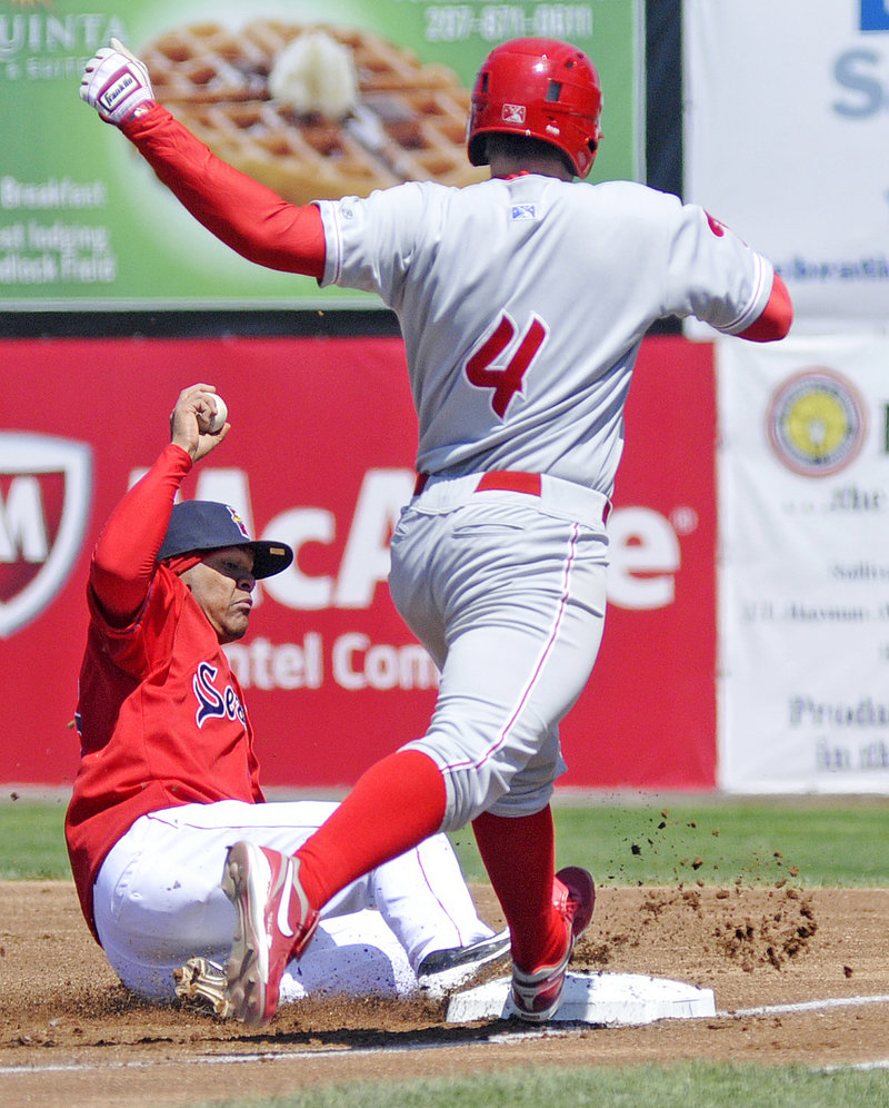 Reynaldo Rodriguez of the Sea Dogs gets to first ahead of Reading runner Darin Ruf in Sunday’s game at Hadlock Field. The Phillies won 4-2.