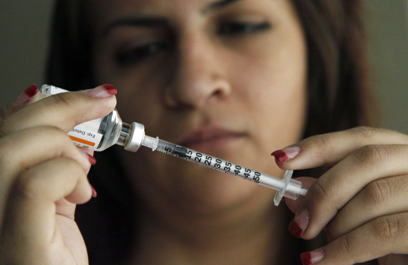 Judith Garcia, 19, prepares to give herself an injection of insulin at her Commerce, Calif., home Sunday. A new study tested three ways to control blood sugar in teens newly diagnosed with diabetes and found that they failed in nearly half the teens within a few years.