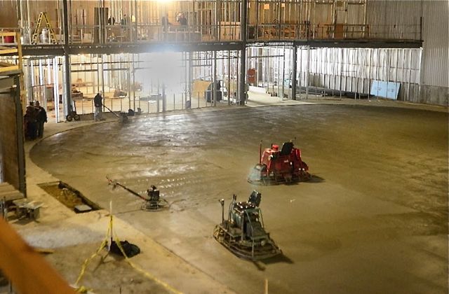 A worker on Wednesday finishes the concrete floor that will be under the ice rink at the new Bank of Maine Ice Vault in Hallowell. The refrigeration pipes are under the 260 yards of concrete and will take 28 days to cure, according to rink manager K.C. Johnson. He said that they plan to have ice by June 1.