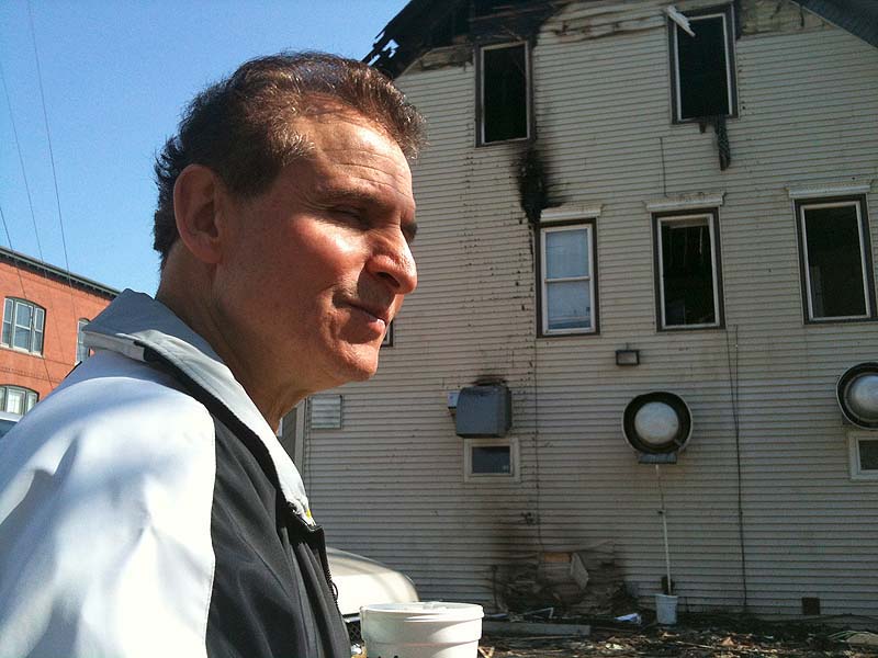 Gorham House of Pizza owner, Angelo Sotiropoulos, at the scene of a fire that heavily damaged an apartment above his business Thursday night. Investigators have determined that an electrical problem was the cause.