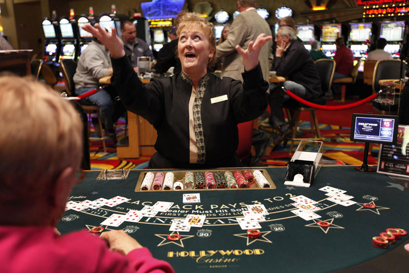 Blackjack dealer Darlene Fellis gestures after dealing a winning hand at Hollywood Slots in Bangor. Mainers in a recent survey said they want the final say in whether to expand gambling in the state.