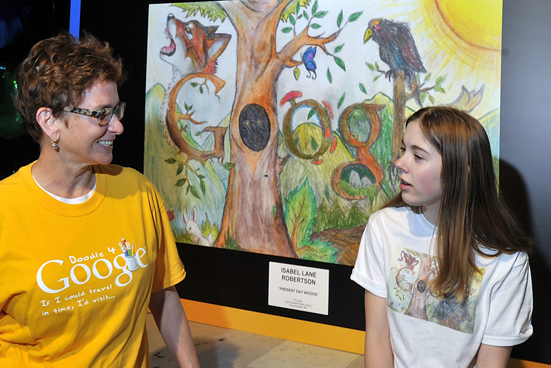 Isabel Robertson, an eighth grader at Cape Elizabeth Middle School, right, chats with her art teacher, Marguerite Lawler-Rohner, in front of her winning drawing before the start of an announcement by Google representatives today. She is one of fifty finalists in the country, one per state, who won a Google award for design. She is Maine's winner and will go to New York for the finals.