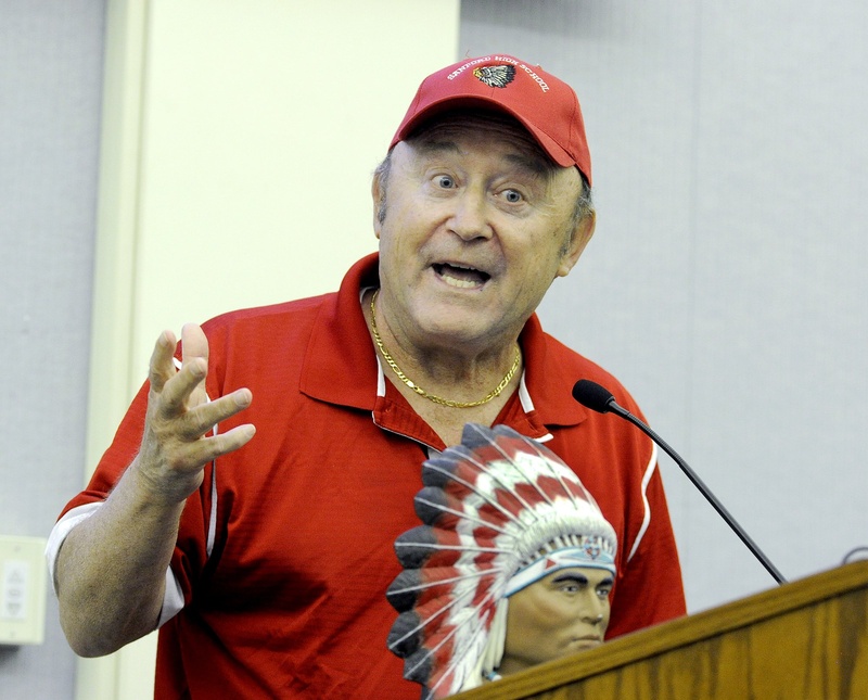 Former high school teacher and coach Roland Cote brought an Indian figurine with him as he spoke against giving up the "Redskins" mascot at Monday's Sanford school board meting. Many who supported keeping the sports team nickname said they were proud to wear their team colors and never meant to insult anyone of Native American origin.