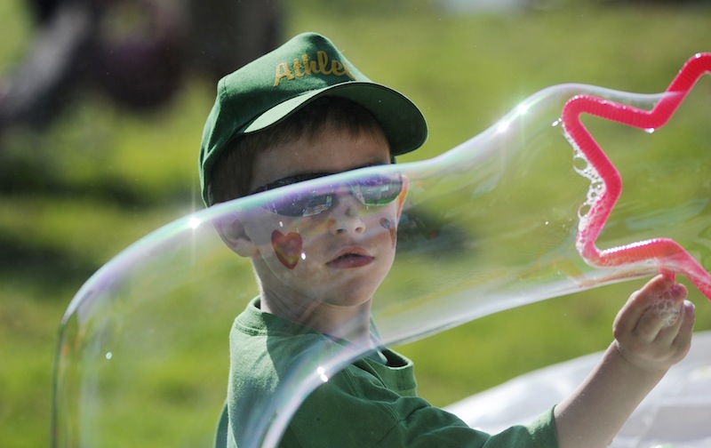 Trevor McDevitt, 6, of Biddeford watches a bubble he is making during the festivities of the American Heart Association's Southern Maine Heart Walk.