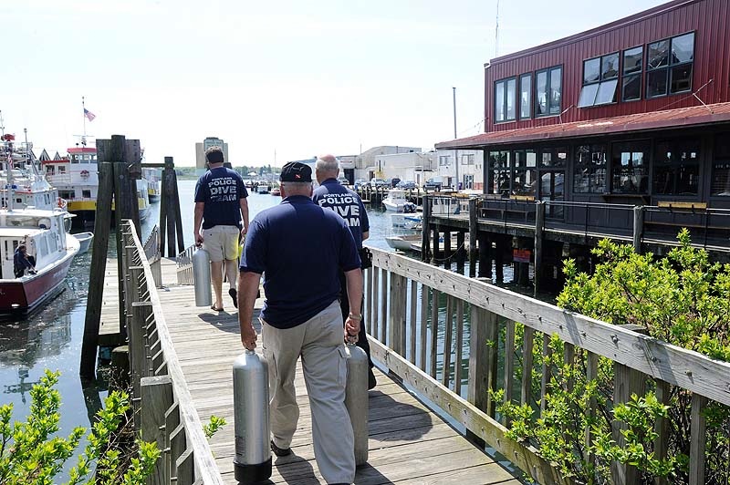 Members of the Portland police dive team assemble at the Portland water taxi ramp Monday, May 21, 2012 to begin another search for a Harvard student who went missing after a night with friends in the Old Port.