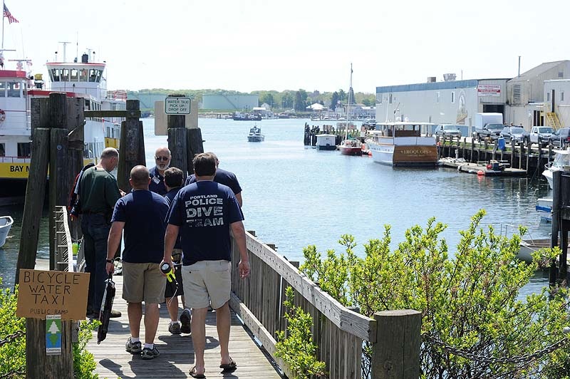 Members of the Portland police dive team assemble at the Portland water taxi ramp Monday, May 21, 2012 to begin another search for a Harvard student who went missing after a night with friends in the Old Port.