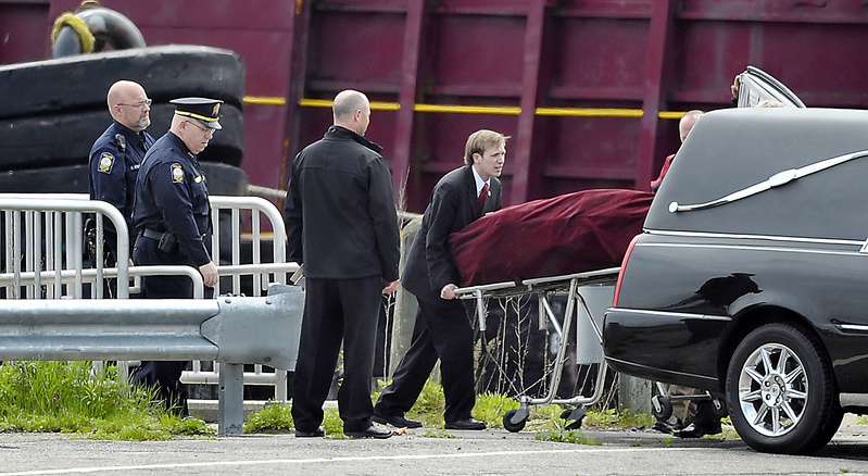 The body of Nathan Bihlmaier is lifted into the waiting hearse at a restricted portion of the Maine State Pier on Tuesday. The hearse took his body to Augusta for an autopsy.