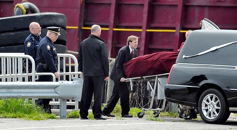 The body of Nathan Bihlmaier is lifted into the waiting hearse at a restricted portion of the Maine State Pier on Tuesday, May 22, 2012. The hearse took his body to Augusta for an autopsy.
