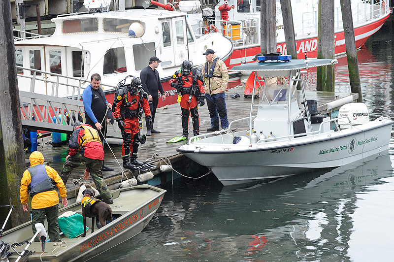 Members of the State and Portland police dive teams search the waters near the State Pier for Nathan Bihlmaier on Monday, May 21, 2012, who went missing after a night with friends in the Old Port.