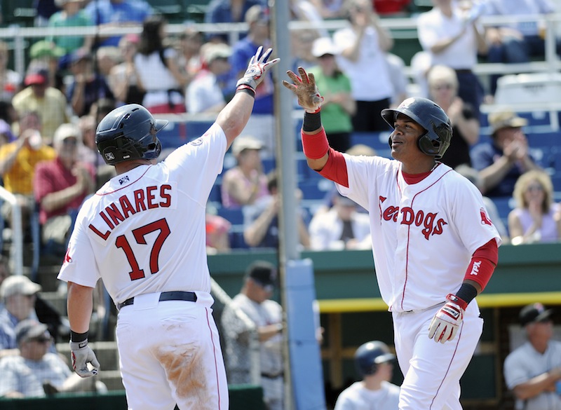 Portland's Juan Carlos Linares, left, greets Reynaldo Rodriguez at home plate after Rodriguez hit a two run home run in the bottom of the fourth inning Sunday, May 27, 2012 against the New Britain Rock Cats. The home run drove in Linares and was the start of a comeback as the Sea Dogs, who were down 4-0, came back to win 8-5.