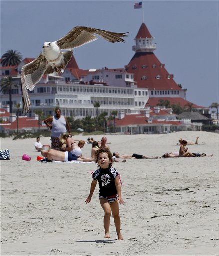 In this May 22, 2012 photo, a child chases a sea gull on the Coronado Beach in Coronado, Calif. The Coronado Beach has been named America's best beach. Coronado Beach tops the 2012 list of Top 10 Beaches produced annually by coastal expert Stephen P. Leatherman, also known as "Dr. Beach," director of Florida International University's Laboratory for Coastal Research. (AP Photo/Lenny Ignelzi)