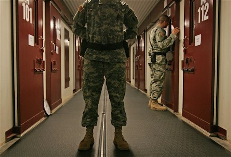 In this Oct. 9, 2007 file photo US military personnel inspect each occupied cell on a two-minute cycle at Camp 5 maximum-security facility on Guantanamo Bay U.S. Naval Base in Cuba. Many of the detainees at Guantanamo have been held since 2002. Five men accused of orchestrating the Sept. 11 attacks, including the self-proclaimed mastermind, are headed back to a military tribunal at Guantanamo Bay more than three years after President Barack Obama put the case on hold in a failed effort to move the proceedings to a civilian court and close the prison at the U.S. base in Cuba. (AP Photo/Brennan Linsley, File)