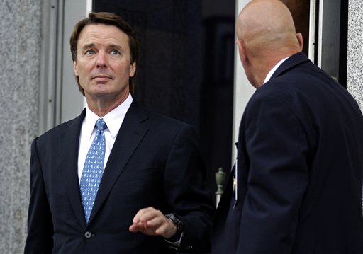 Former presidential candidate and Sen. John Edwards, left, leaves a federal courthouse in Greensboro, N.C., on Tuesday. Edwards is accused of conspiring to secretly obtain more than $900,000 from two wealthy supporters to hide his extramarital affair with Rielle Hunter and her pregnancy. He has pleaded not guilty to six charges related to violations of campaign-finance laws.