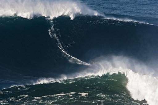 In this photo Nov. 1, 2011, photo, Garrett McNamara, of Hawaii, surfs what is being called the tallest wave ever ridden at the Praia do Norte beach in Nazare, Portugal. McNamara took away honors at the Billabong XXL Big Wave Awards Friday May 4, 2012 and also set a world surfing record for surfing a wave measured by experts as 78 feet. A panel of big wave surfing and photography experts, who analyzed and measured the photos and videos of Garrett's ride, determined the height of the wave.