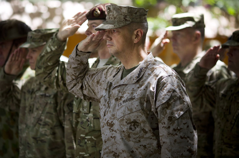 Gen. John Allen, center, the top U.S. commander in Afghanistan, salutes before he observes Memorial Day by reading a letter written by an American soldier to his family before he died earlier this year, at the ISAF headquarters in Kabul, Afghanistan, Monday, May 28, 2012.