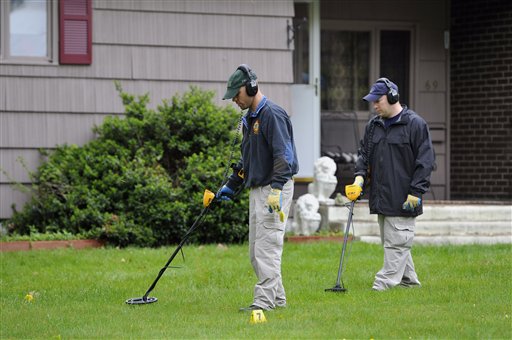 Law enforcement agents search the yard at the home of reputed Connecticut mobster Robert Gentile in Manchester, Conn., today. Gentile's lawyer A. Ryan McGuigan says the FBI warrant allows the use of ground-penetrating radar and believes they are looking for paintings stolen in 1990 from Boston's Isabella Stewart Gardener Museum worth half a billion dollars.