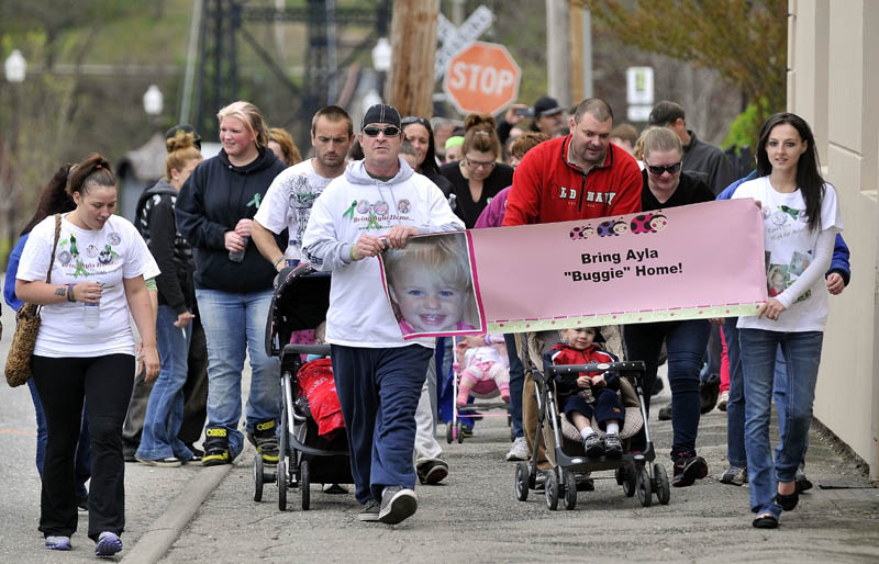 TRYING TO HELP: Participants of the Eyes Open Walk for Baby Ayla travel down Temple Street in downtown Waterville to help keep missing toddler Ayla Reynolds in the news on Saturday.