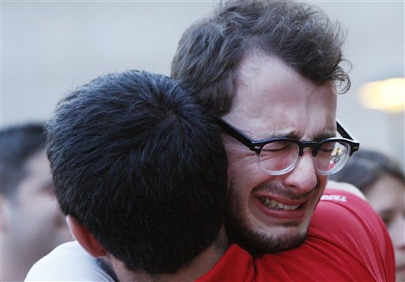 Boston University student Blake Wrobbel, of Los Angeles, right, gets emotional during a candlelight vigil on Marsh Plaza at Boston University, Saturday, May 12, 2012, for three students studying in New Zealand who were killed when their minivan crashed during a weekend trip. Daniela Lekhno, 20, of Manalapan, N.J.; Austin Brashears, 21, of Huntington Beach, Calif.; and Roch Jauberty, 21, whose parents live in Paris, were killed as they travel in a minivan at about 7:30 a.m. Saturday near the North Island vacation town of Taupo when the vehicle drifted to the side of the road and then rolled when the driver tried to correct course. (AP Photo/Bizuayehu Tesfaye)