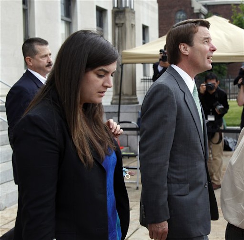 Cate Edwards looks down as she walks with her father, John Edwards as he checks the stormy skies as they both exit a federal courthouse in Greensboro, N.C., Monday, May 14, 2012. John Edwards is on trial for campaign corruption. (AP Photo/Bob Leverone)