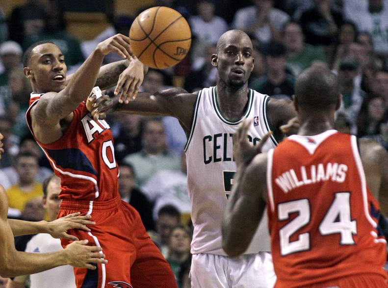 Atlanta guard Jeff Teague, left, passes off to teammate Marvin Williams against Boston's Kevin Garnett in Game 3 of the Eastern Conference quarterfinals Friday.