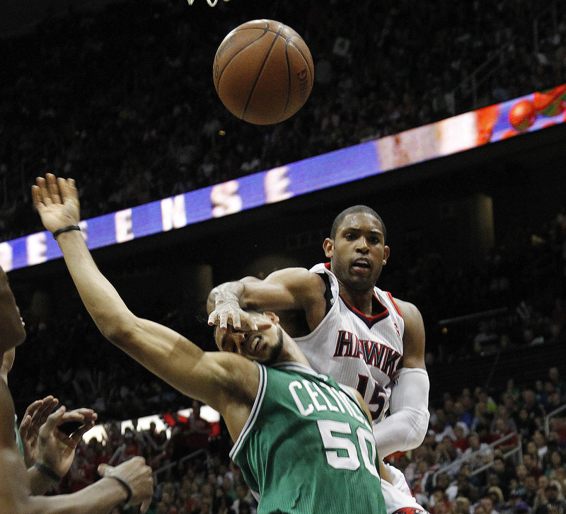 Atlanta Hawks center Al Horford and Boston Celtics center Ryan Hollins battle for a loose ball during the second half of Game 5 of a first-round playoff series game Tuesday in Atlanta. Atlanta won 87-86.