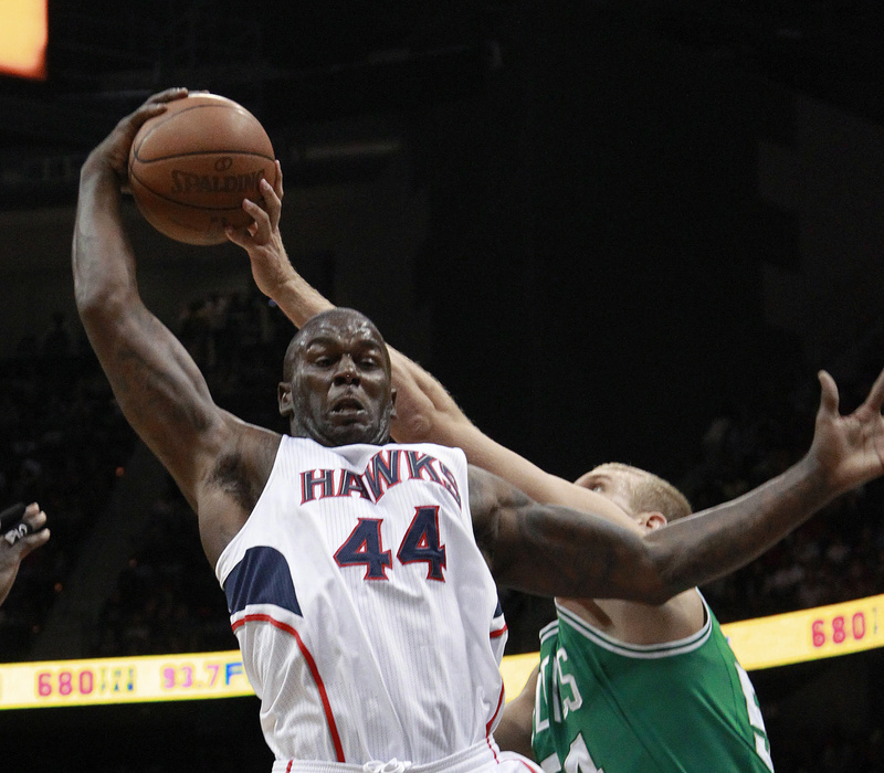 Atlanta Hawks forward Ivan Johnson (44) and Boston Celtics center Greg Stiemsma (54) vie for a rebound in the first half of Game 2 of the first-round playoff series Tuesday in Atlanta.