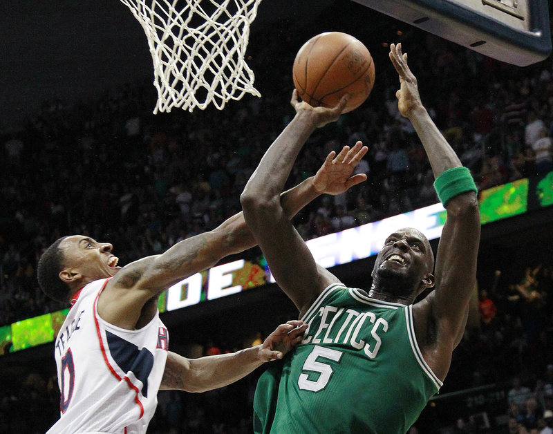 Boston Celtics' Kevin Garnett pulls down a rebound as Atlanta Hawks guard Jeff Teague defends in the second half of Game 2 of the first-round playoff basketball series Tuesday in Atlanta. Boston won 87-80 and evened the series at one game each.