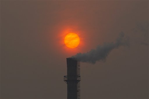 Smoke billows from a chimney of a heating plant as the sun sets in Beijing in this Feb. 13, 2012 photo. Scientists say carbon emissions from fast-growing economies like China and India as well as developed industrialized nations tare overheating the planet.