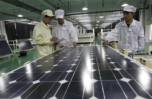 Chinese workers examine solar panels recently at a manufacturer of photovoltaic products in Huaibei in central China's Anhui province.