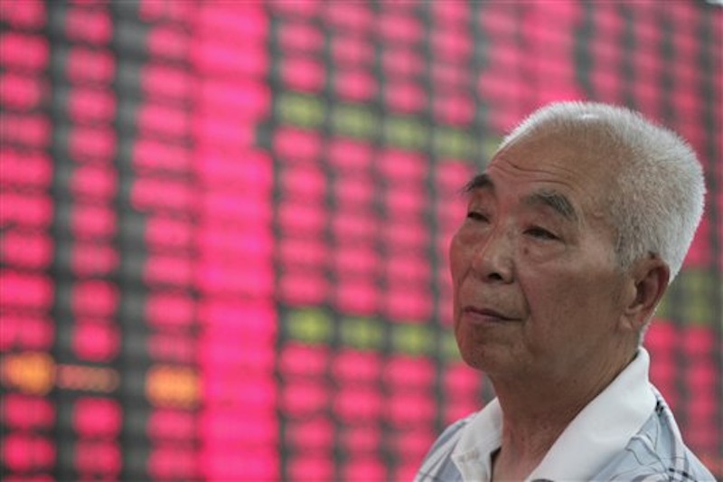 An investor looks at the stock price update on a monitor at a private securities company in Shanghai, China, Tuesday May 22, 2012. Hopes China will announce new measures to boost economic growth helped push Asian stock markets higher Tuesday. (AP Photo)