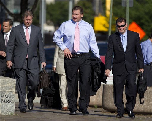 Former Major League Baseball pitcher Roger Clemens, center, arrives at federal court in Washington today.