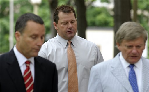 Former Major League baseball pitcher Roger Clemens, center, and his legal team, arrive at federal court in Washington on Wednesday.