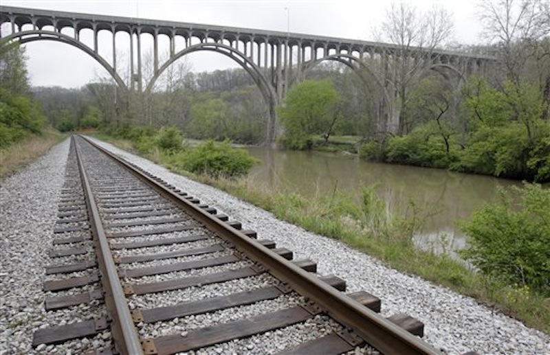 Tracks for the Cuyahoga Valley Scenic Railroad run under a bridge at the Cuyahoga Valley National Park in Brecksville, Ohio, on Tuesday, May 1, 2012. Five men have been arrested for conspiring to blow up the high level bridge over the Cuyahoga River valley, but there was no danger to the public because the explosives were inoperable and were controlled by an undercover FBI employee, the agency said Tuesday in announcing the men's arrests. (AP Photo/Amy Sancetta)