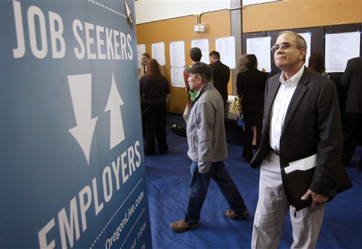 Job seeker Alan Shull attends a job fair recently in Portland, Ore. The Labor Department said today that the economy added just 115,000 jobs in April. as U.S. employers pulled back on hiring for the second straight month.