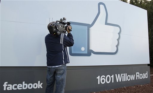 A television cameraman shoots the Like sign outside of Facebook headquarters in Menlo Park, Calif., today.