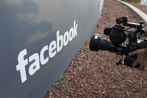 A television camerman shoots the sign outside of Facebook headquarters in Menlo Park, Calif., today.