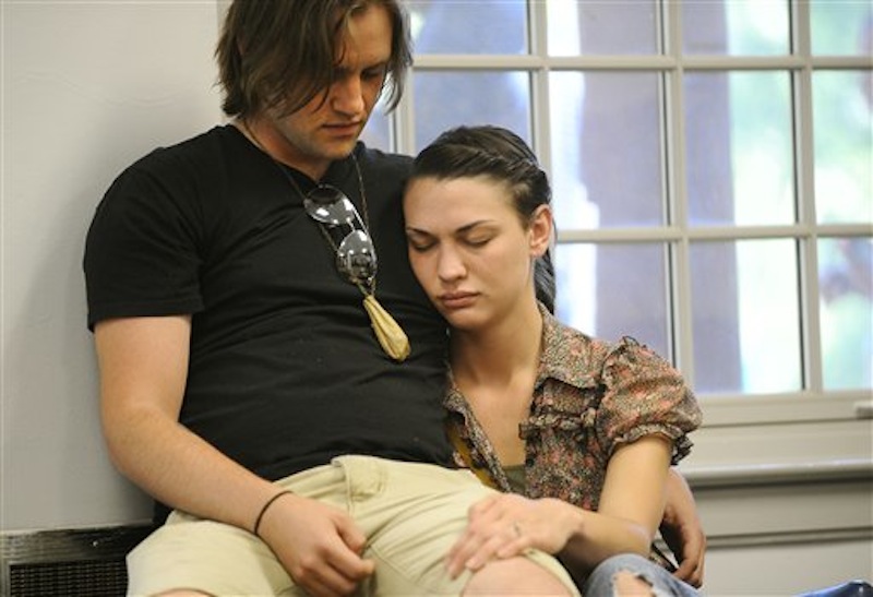Jesse Duke, left, and his fiance Whitney Hall hug at a vigil for University of West Georgia student Aimee Copeland Thursday, May 10, 2012 in Melson Hall on the campus of the University of West Georgia in Carrollton, Ga. Doctors say Copeland, who is fighting a flesh-decaying bacteria she contracted after a zip line accident, will lose her hands and remaining foot to the infection. Duke works with Copeland. (AP Photo/Times-Georgian, Cliff Williams)