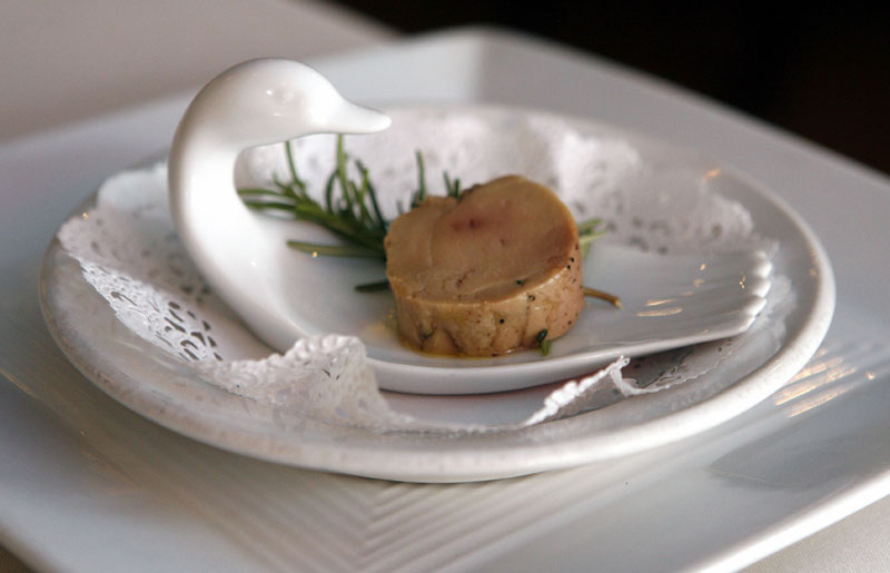 A serving of salt-cured fresh foie gras with herbs is displayed at Chef Didier Durand's Cyrano's Bistrot and Wine Bar in Chicago. Back in 2005, the California legislature gave foie gras producers seven years to find a humane way to create the fatty duck liver delicacy without forcing food down the birds' throats. With the July 1, 2012 deadline looming, an attempt by some of the state's top chefs to overturn the law has the bill's original sponsor alleging that opponents have gone back on their word. A similar ban in Chicago was repealed in 2008.