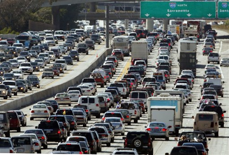 In this May 28, 2010 file photo, the rush hour commute starts in early afternoon and with greater intensity as traffic is jammed in both directions on Interstate 405 on the Westside of Los Angeles as commuters and vacationers hit the road. More Americans will hit the road this holiday weekend than a year ago. And they'll have a little extra money to spend thanks to lower gas prices. It’s Memorial Day weekend and our obsession with the price of gasoline is in focus again. (AP Photo/Reed Saxon, file)
