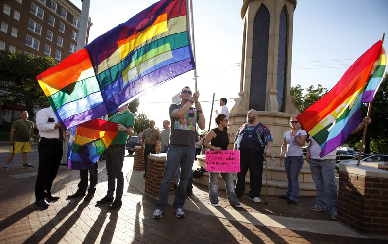 Dale Robinson waves his flag at a rally of the Dallas LGBT Community to applaud President Obama's stance on Gay marriage.
