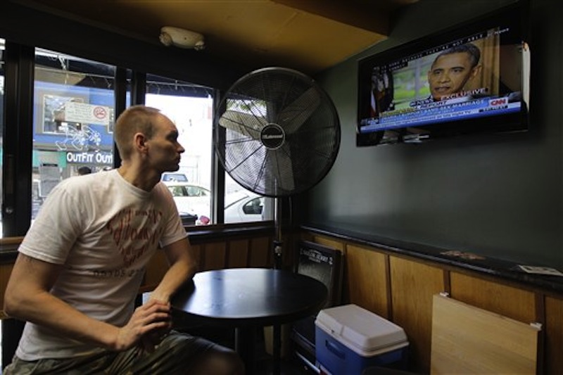 Jase Peeples watches a television broadcast of President Obama declaring his support of same-sex marriage Wednesday, May 9, 2012, at The Mix bar in San Francisco. President Obama on Wednesday announced that he now supports same-sex marriage, reversing his longstanding opposition amid growing pressure from the Democratic base and even his own vice president. Peeples, who has lived with his partner for nine years, welcomed the news. (AP Photo/Ben Margot)