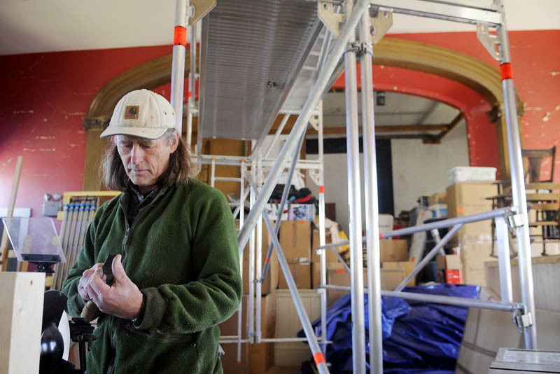 Erik Groenhout insects a woodworking tool he sharpened Monday in the interior of the former Odd Fellows Lodge he is restoring in Mount Vernon. The Dutch woodworker is restoring the prominent structure on Minnehonk Lake to open a cabinet making business.