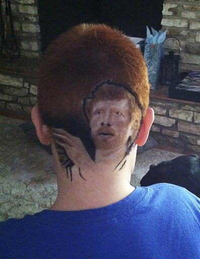 This family photo shows Patrick Gonzalez, 12, with an image of San Antonio Spurs' Matt Bonner shaved into his head. He returned to school Thursday after reluctantly shaving his head.