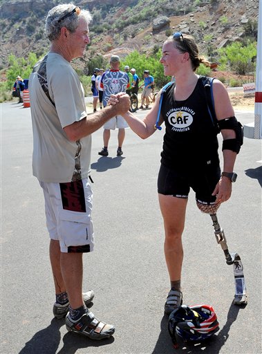 Former President George W. Bush shakes hands with retired U.S. Army 1st Lt. Melissa Stockwell at the end of the Bush Center Warrior 100K Race at Palo Duro Canyon State Park in Amarillo, Texas, on April 26. Bush hosted the 100-kilometer mountain bike ride for military members wounded in Iraq and Afghanistan.