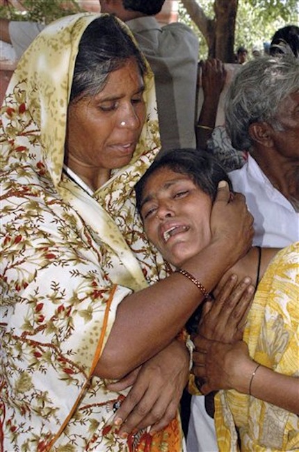 Relatives of victims of a train accident cry outside a government hospital in Penukonda, about 170 kilometers (105 miles) north of Bangalore, India, Tuesday, May 22, 2012. A passenger train rammed into a parked freight train and burst into flames before dawn Tuesday, killing more than a dozen people in southern India, officials said. (AP Photo)
