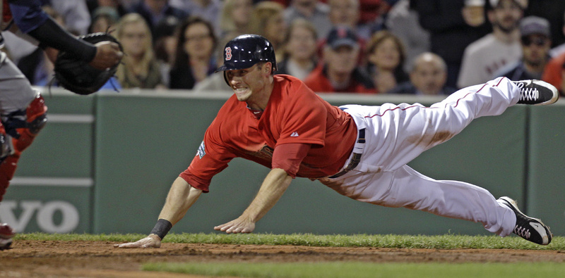 Boston's Daniel Nava dives into home plate to score on a hit by Cody Ross in the fifth inning against the Cleveland Indians at Fenway Park in Boston on Friday.