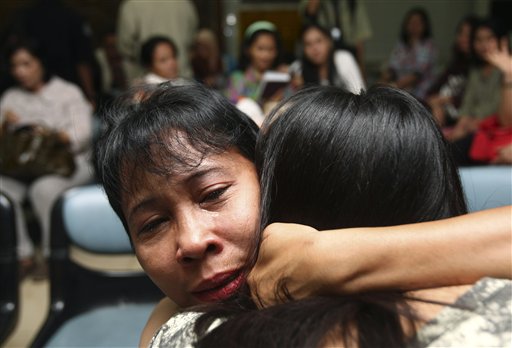 A relative weeps as she and others wait for the latest news on the Russian passenger jet that crashed into a steep cliff on a long-dormant Indonesian volcano on Wednesday, at Halim Perdanakusuma Airport in Jakarta, Indonesia, today.