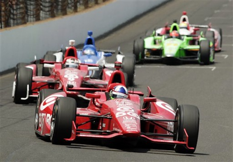 Dario Franchitti, of Scotland, leads teammate Scott Dixon, center, of New Zealand, and Takuma Sato, of Japan, into the first turn during IndyCar's Indianapolis 500 auto race at Indianapolis Motor Speedway in Indianapolis, Sunday, May 27, 2012. (AP Photo/AJ Mast)
